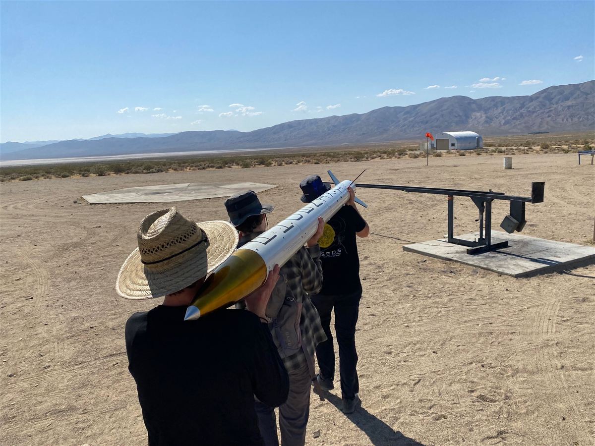 the team carrying phoenix ii out to the rail